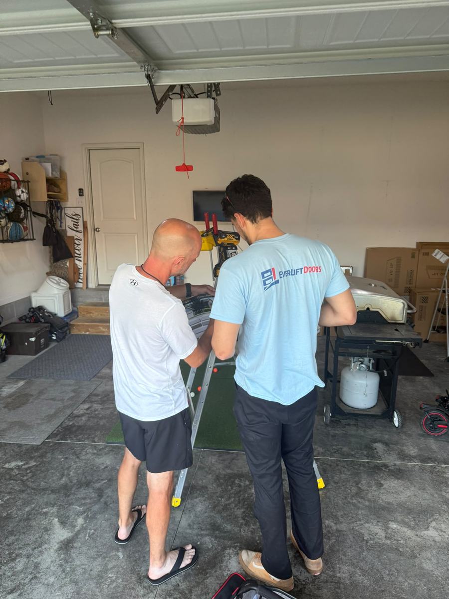 EverLift Doors technician installing and testing a garage door opener in a Kentucky home garage