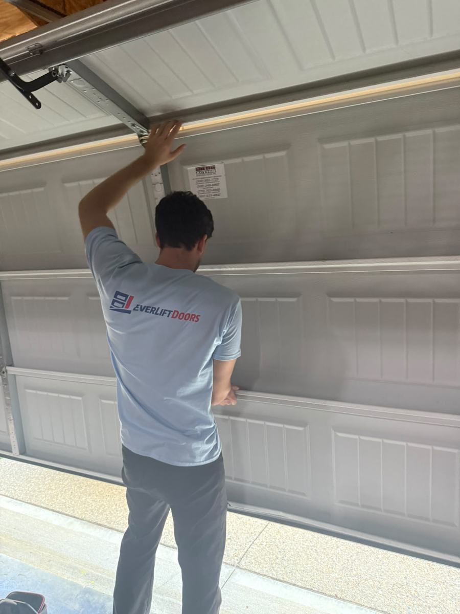 EverLift Doors technician fitting a new garage door panel during an installation at a Kentucky home
